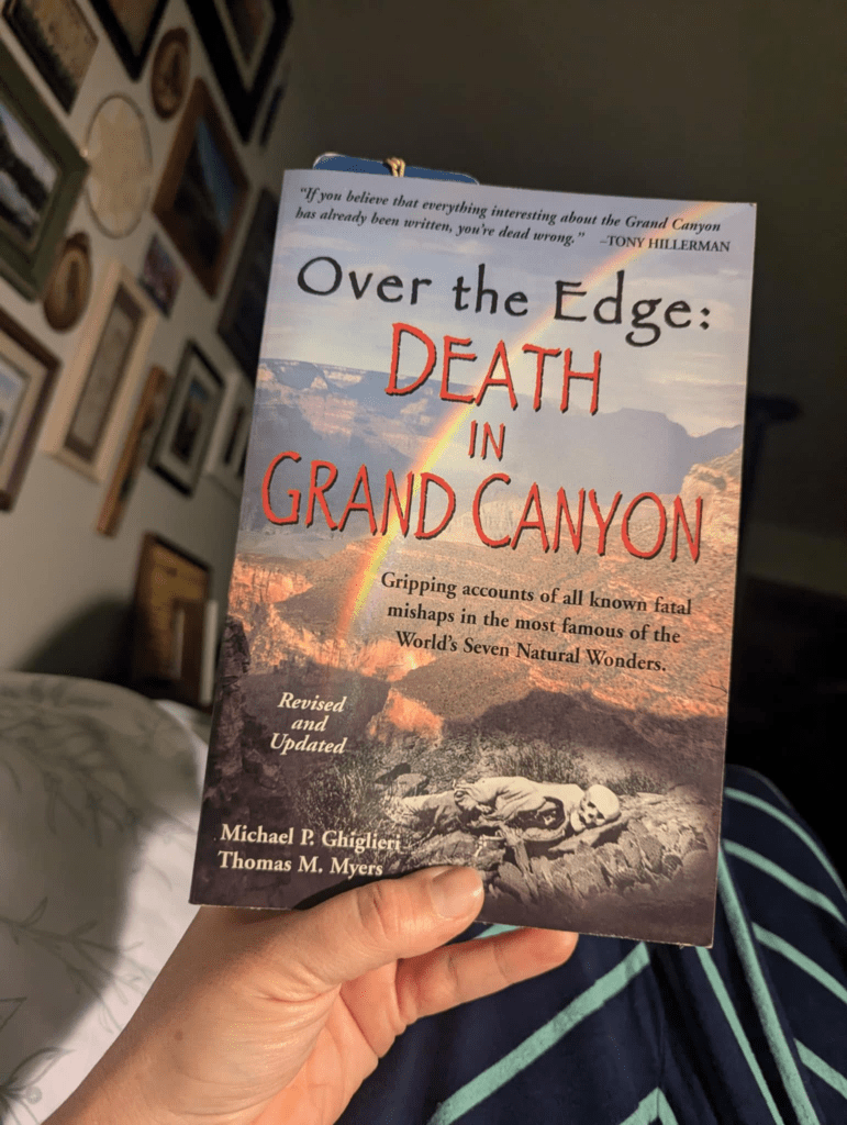 picture of a woman's hands holding up the book "Over the Edge: Death in Grand Canyon" by Michal P. Ghiglieri and Thomas M. Myers.